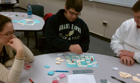 Three students playing the 3-player version of the game.